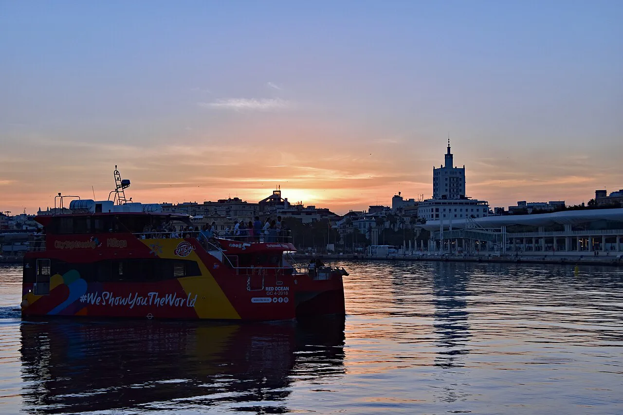Red Ocean (Ship, ?) arriving in Malaga with sun down in the backgroup